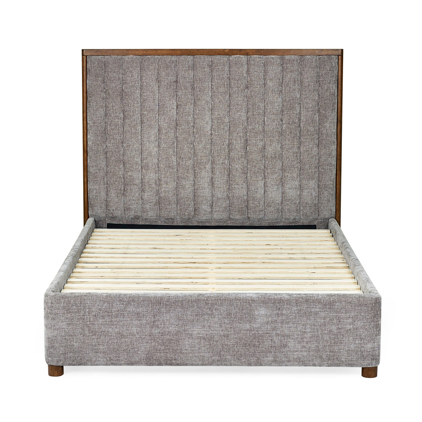 Side view of upholstered bed frame in grey fabric with wooden slats and tall channel-tufted headboard