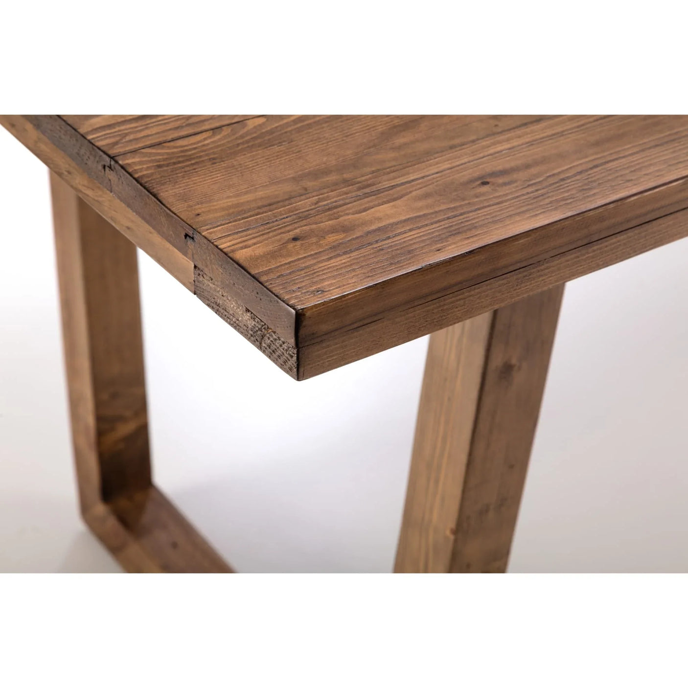 Solid wood dining table with rectangular legs and natural finish, corner detail view