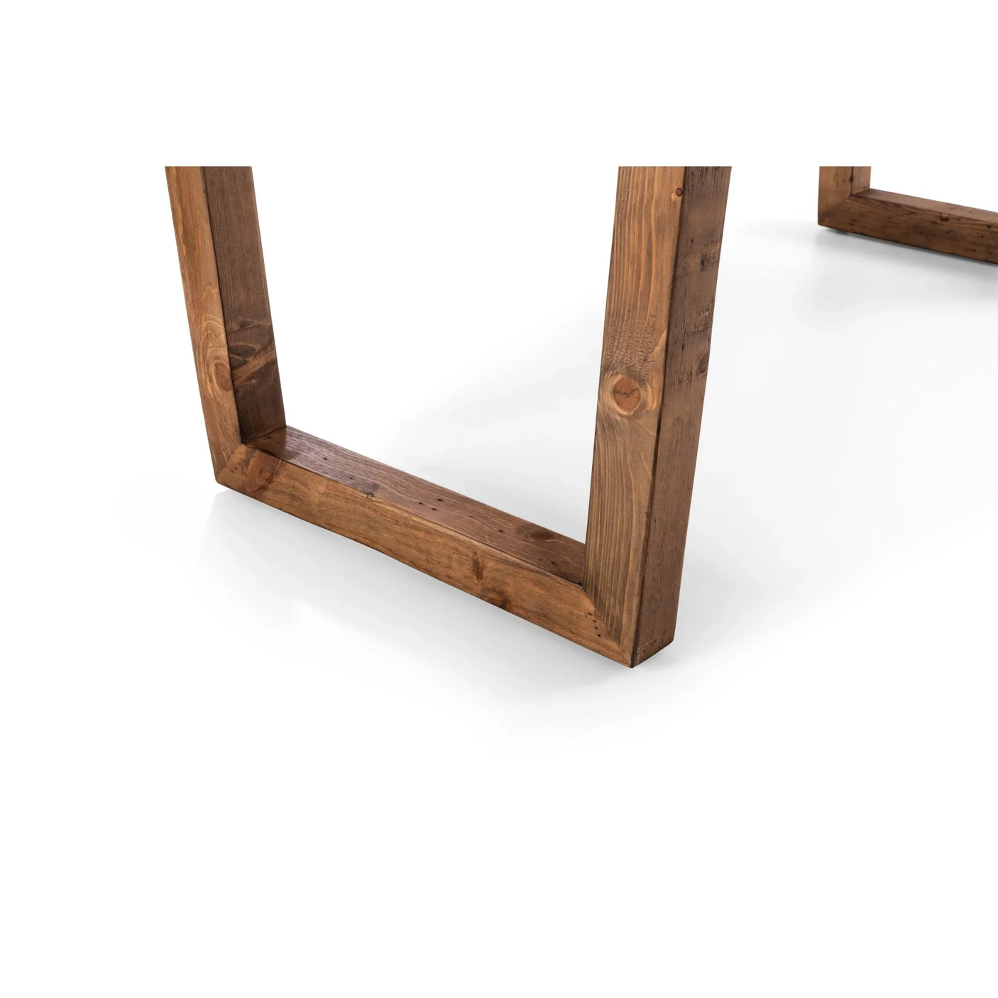 Closeup of solid wood dining table legs with natural grain on white background