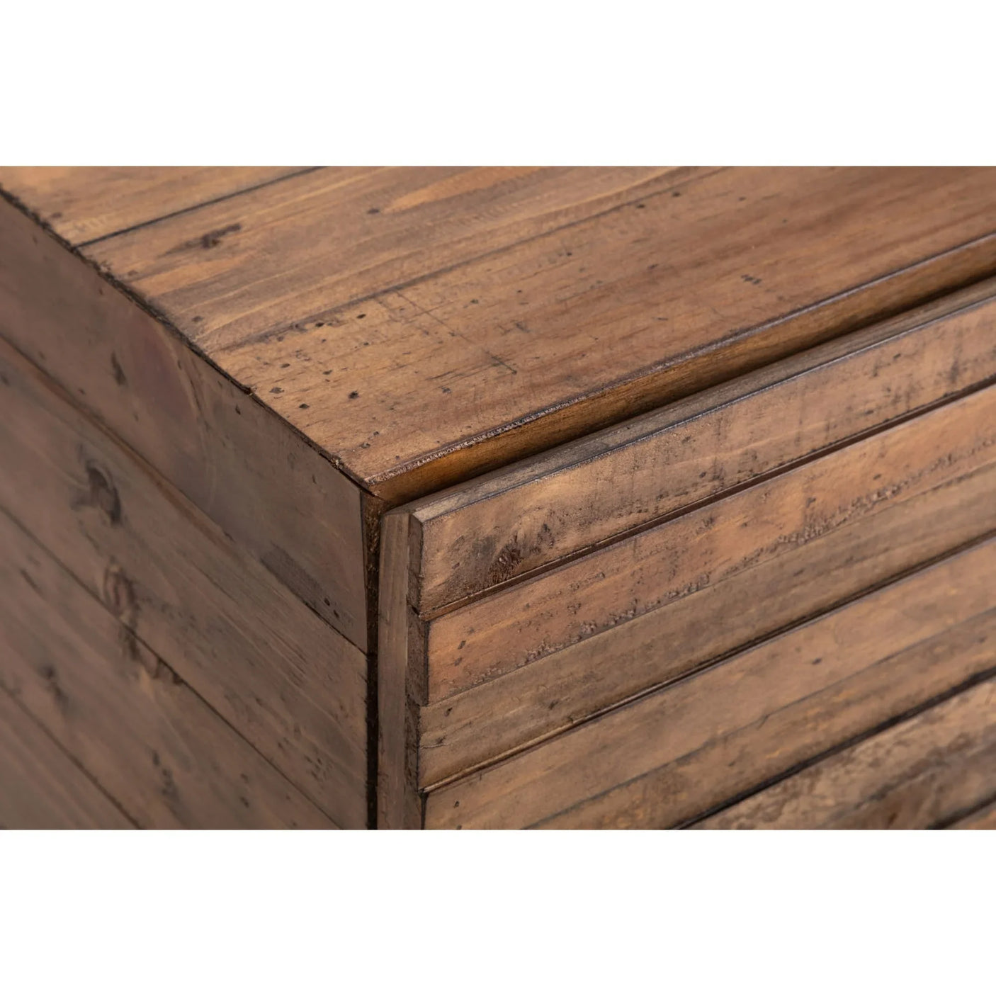 Close up of wooden chest of drawers corner with natural grain and horizontal slats