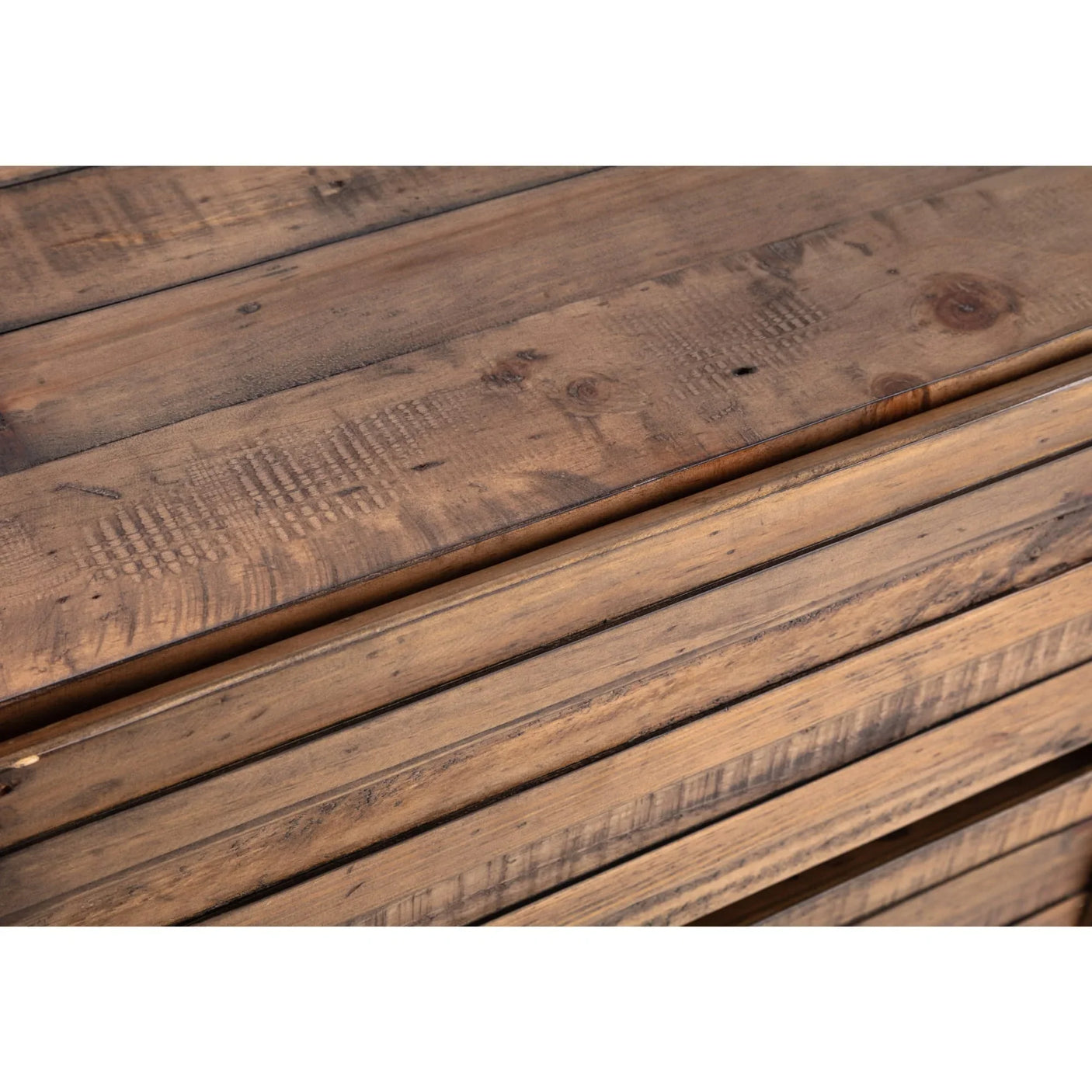 Close-up of wooden dresser drawer fronts with natural grain and rustic finish