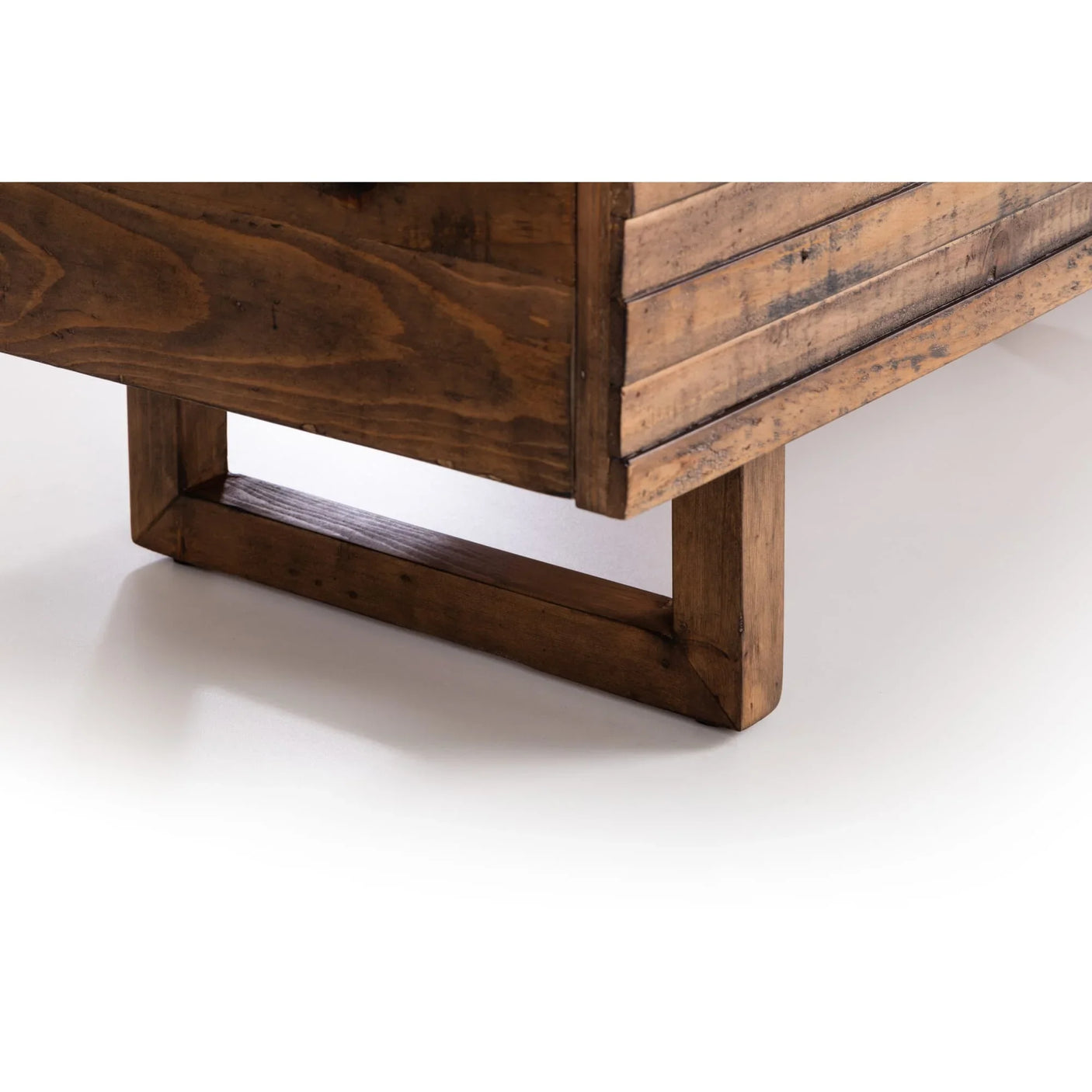 Close-up of wooden furniture leg with rectangular base and rustic finish