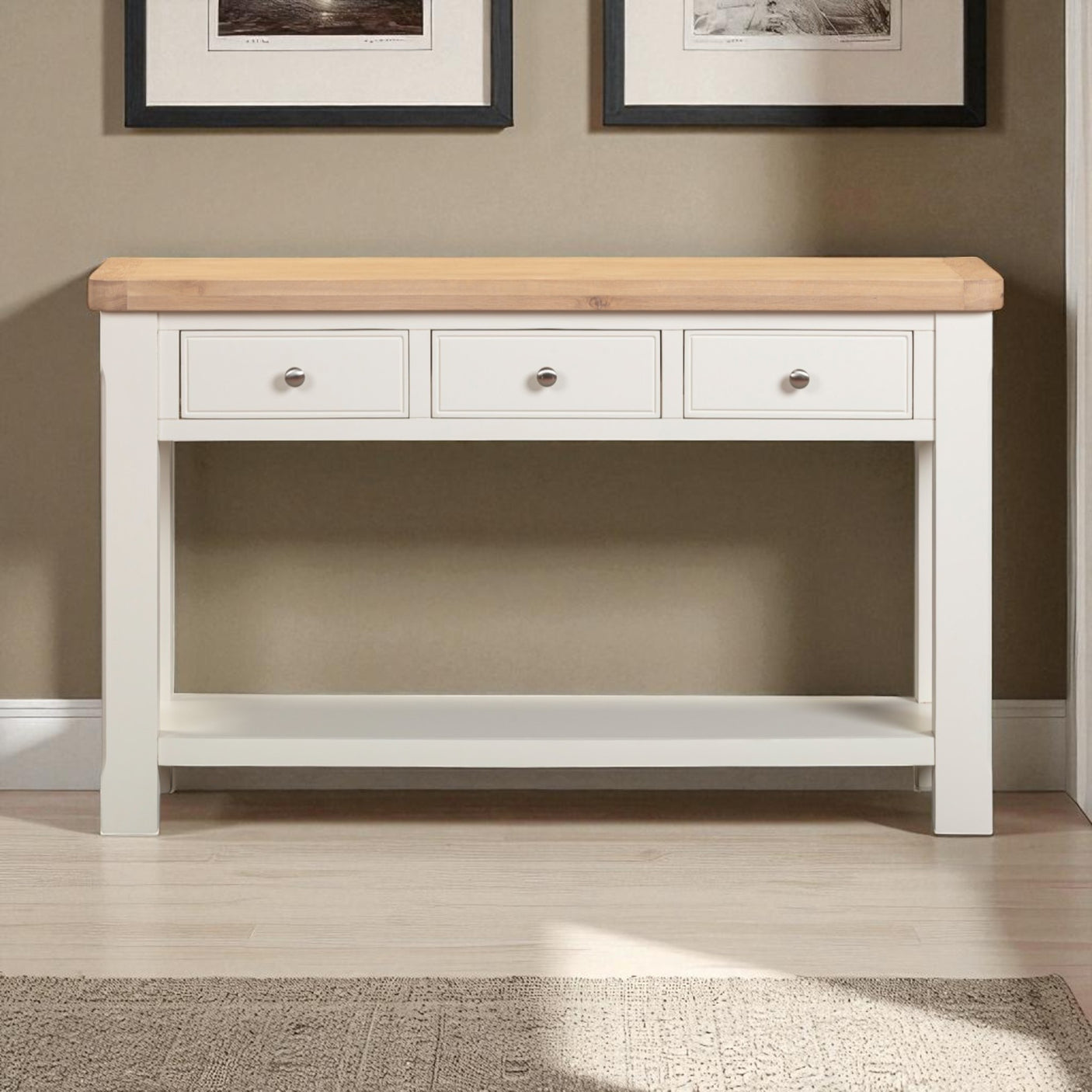White console table with wooden top against a wall with framed pictures.
