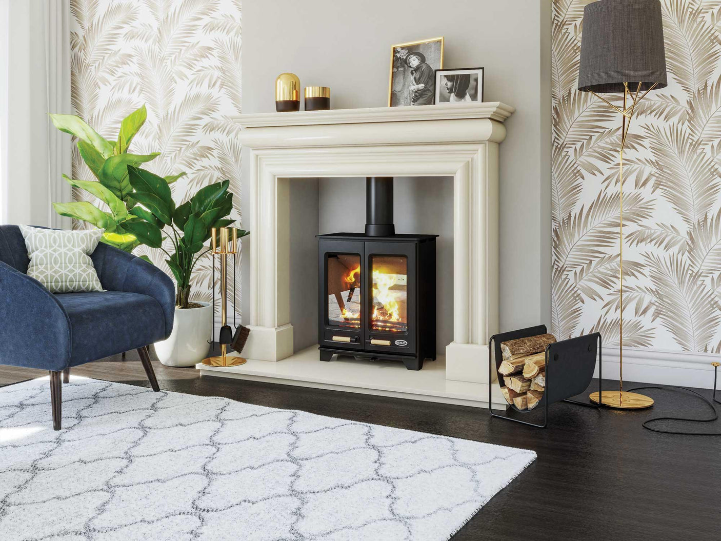 Modern living room with log burner fireplace, navy armchair, and patterned rug