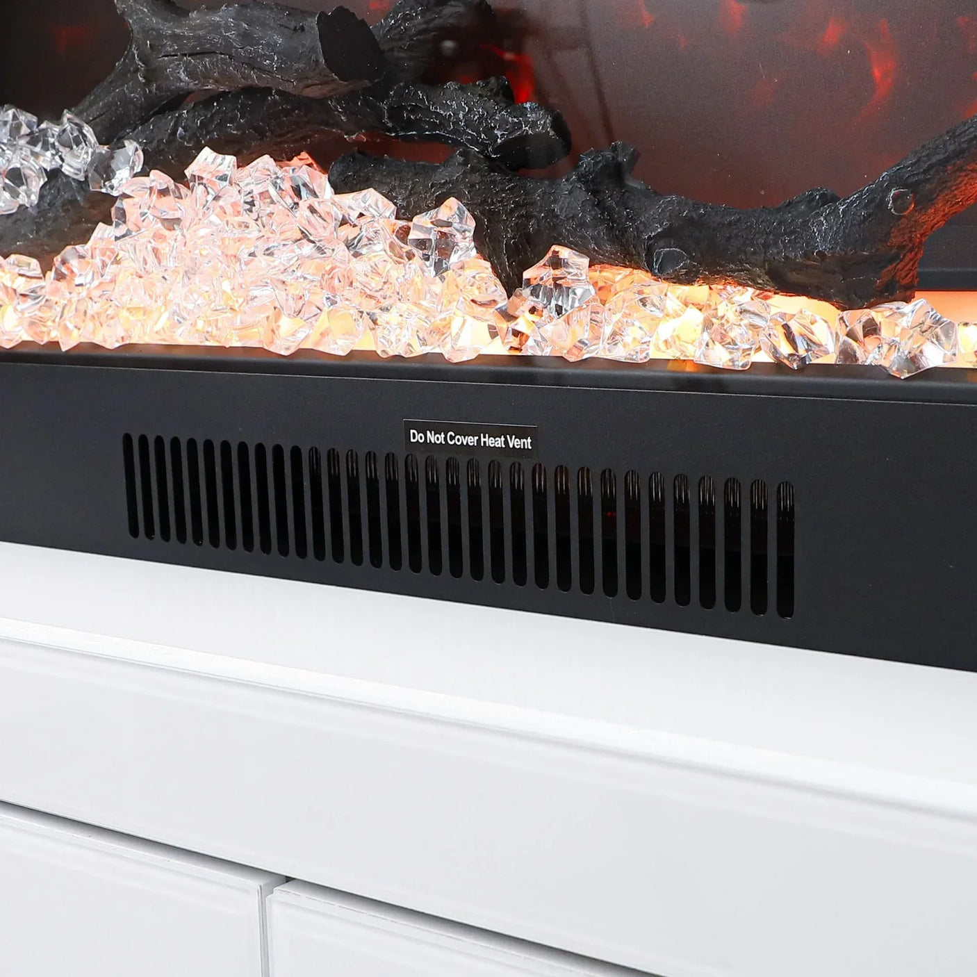 Electric fire with crystal stones, black heat vent, and white unit front view