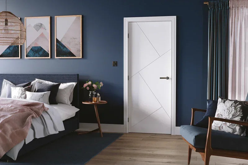 White interior door with modern geometric pattern in stylish blue bedroom setting