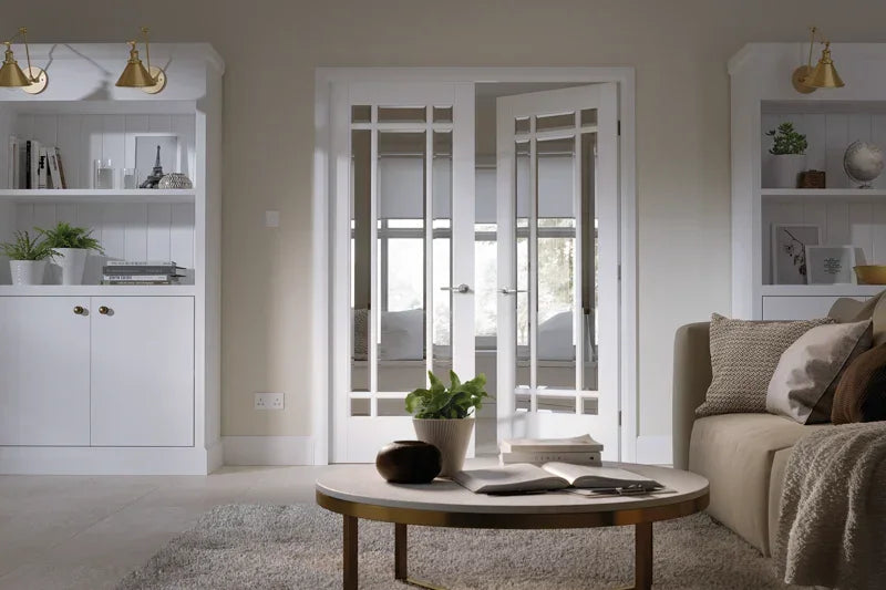 White Manhattan glazed internal doors in modern living room with coffee table and shelves