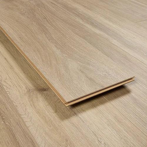 Whitewashed oak laminate flooring plank with wood grain texture on matching floor surface