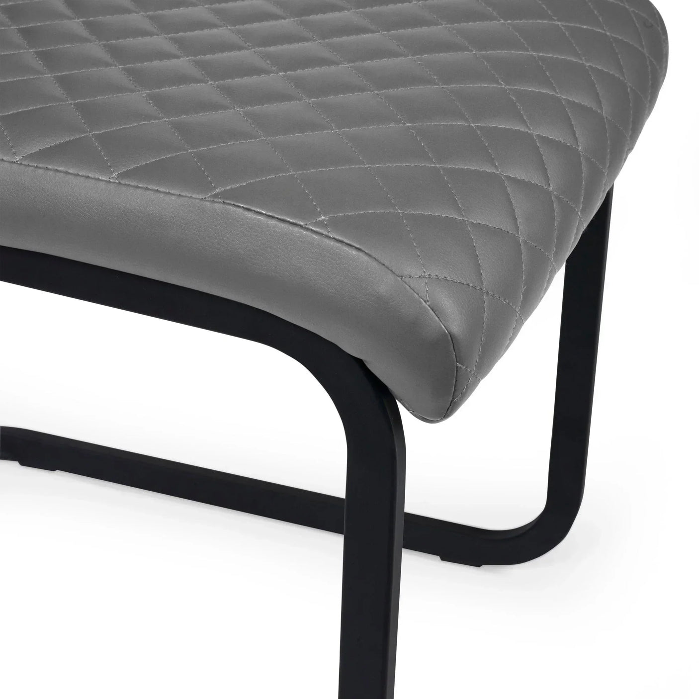 Grey faux leather dining chair seat with quilted stitching and black metal legs