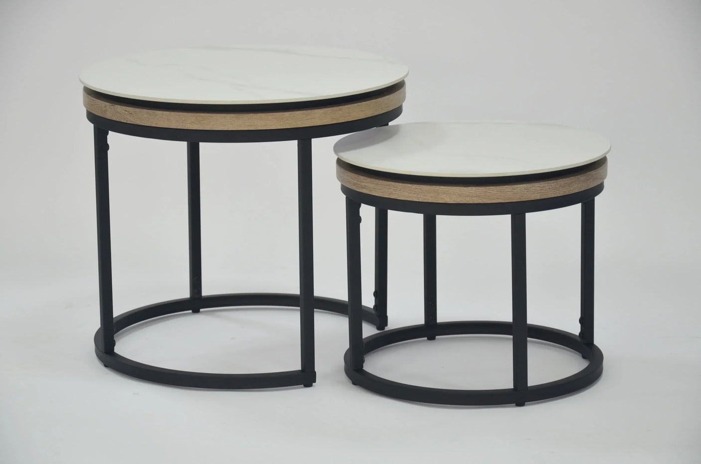 Round nest of tables with white tops, black metal frames, and wood trim on white background