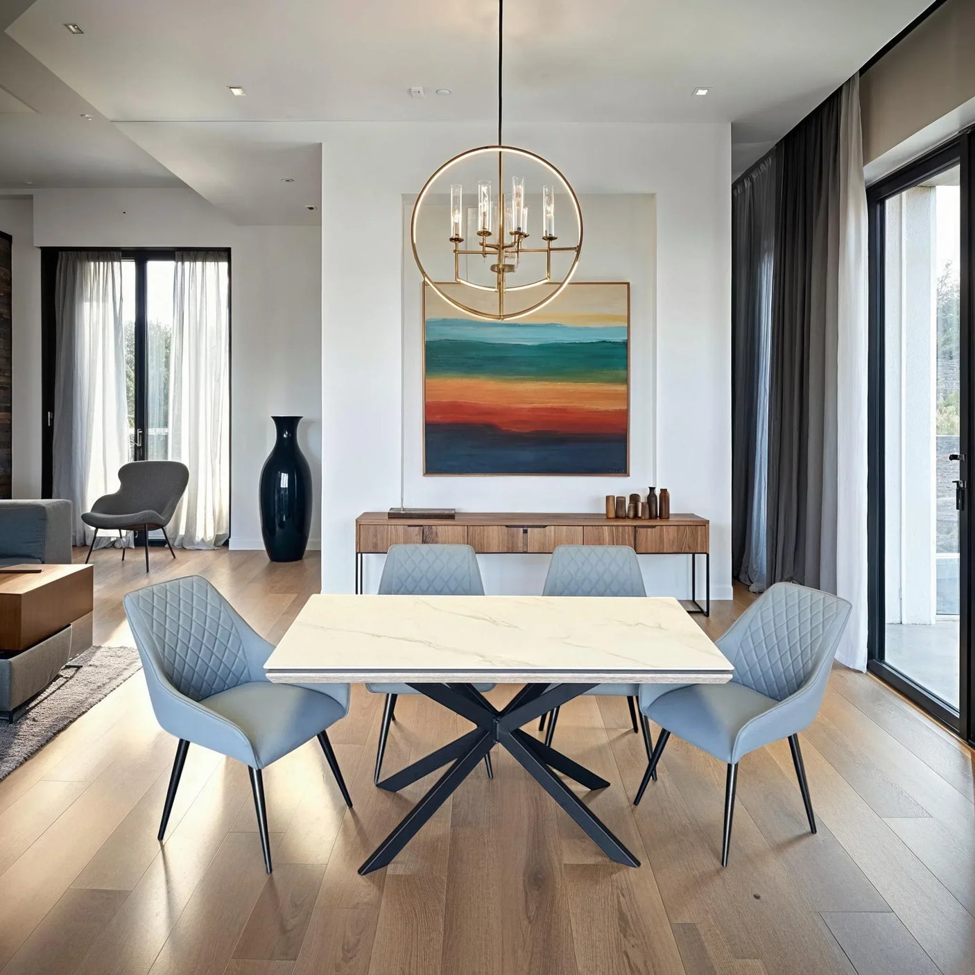 Modern dining table with marble top and four grey quilted chairs in bright dining room