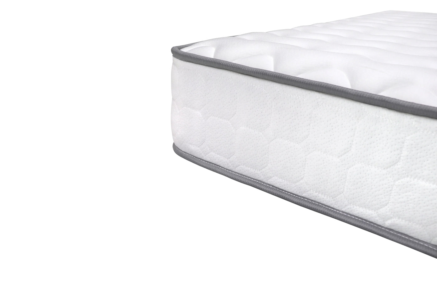 White mattress with quilted surface and grey trim closeup on corner