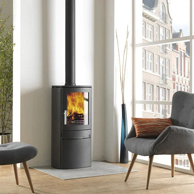 Modern black wood burning stove with glass door in a bright living room