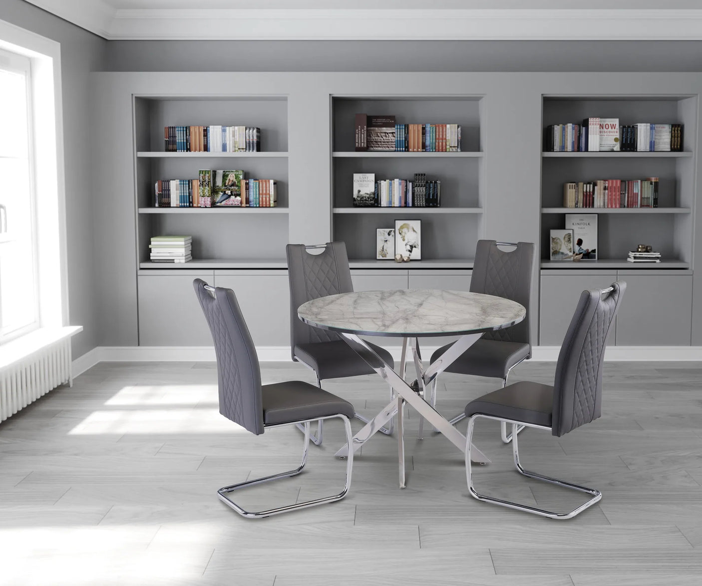 Dining area with a round table and four chairs in a room with bookshelves.