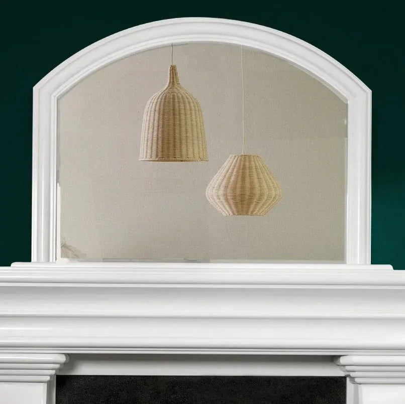 Arch overmantle mirror in honed polar white finish above fireplace mantel