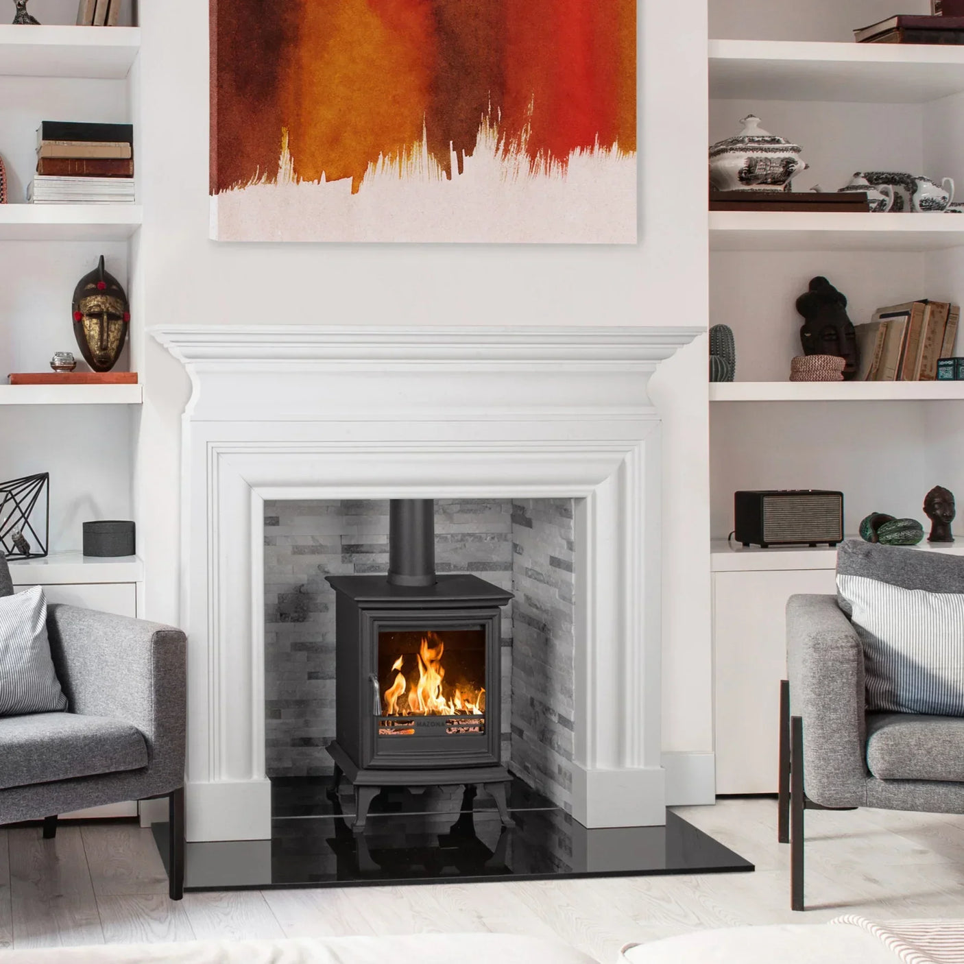White fireplace surround set with wood burning stove in modern living room arrangement
