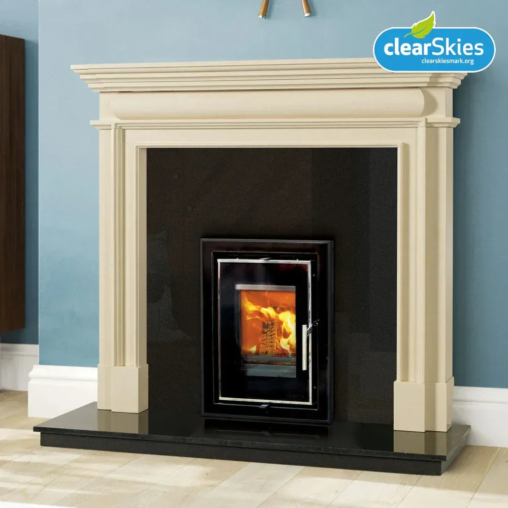 Cream fireplace with black inset wood burning stove against light blue wall
