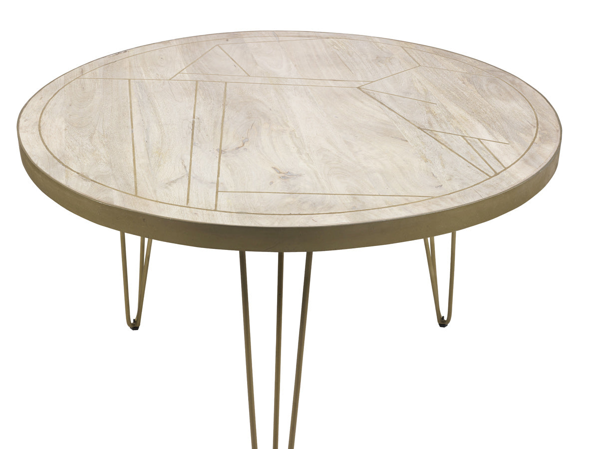 Light gold round dining table with metal inlays and angled legs