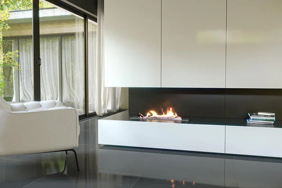 Modern bioethanol burner set in white living room with glass doors and black tile floor