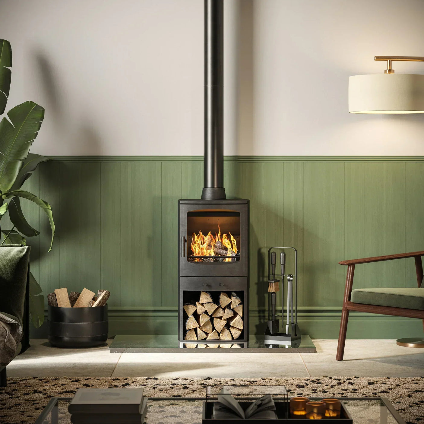 Log burner with stacked firewood in modern living room, green panel wall and armchair