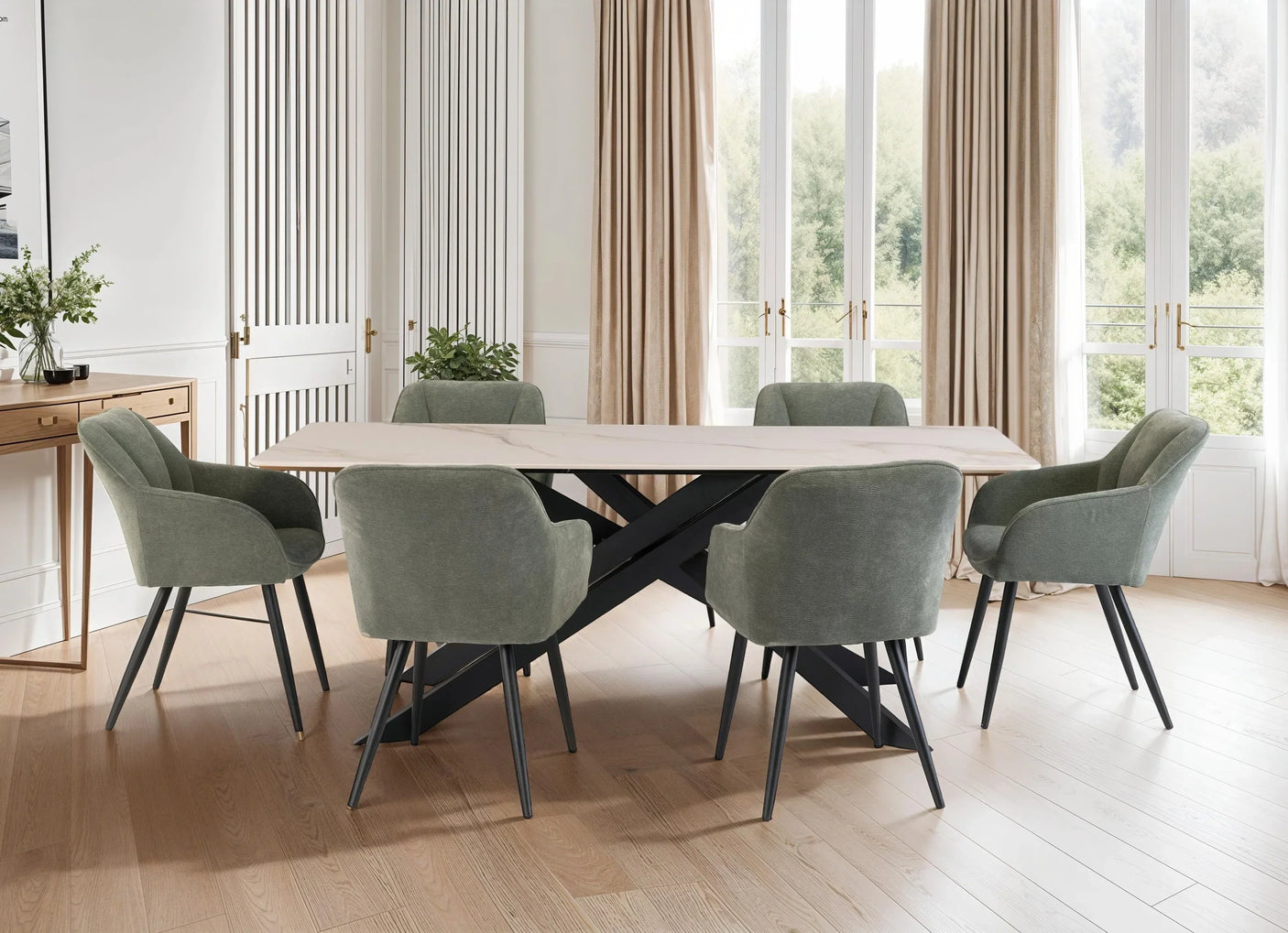 Modern dining table with marble top and six sage green velvet chairs in bright dining room