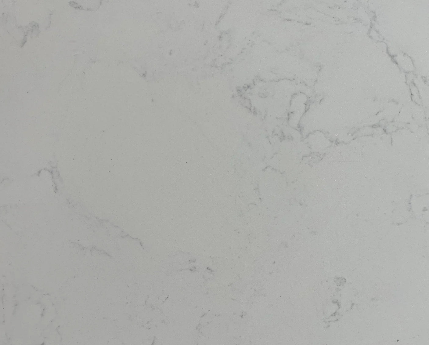 Close-up of white marble tabletop with subtle grey veining pattern