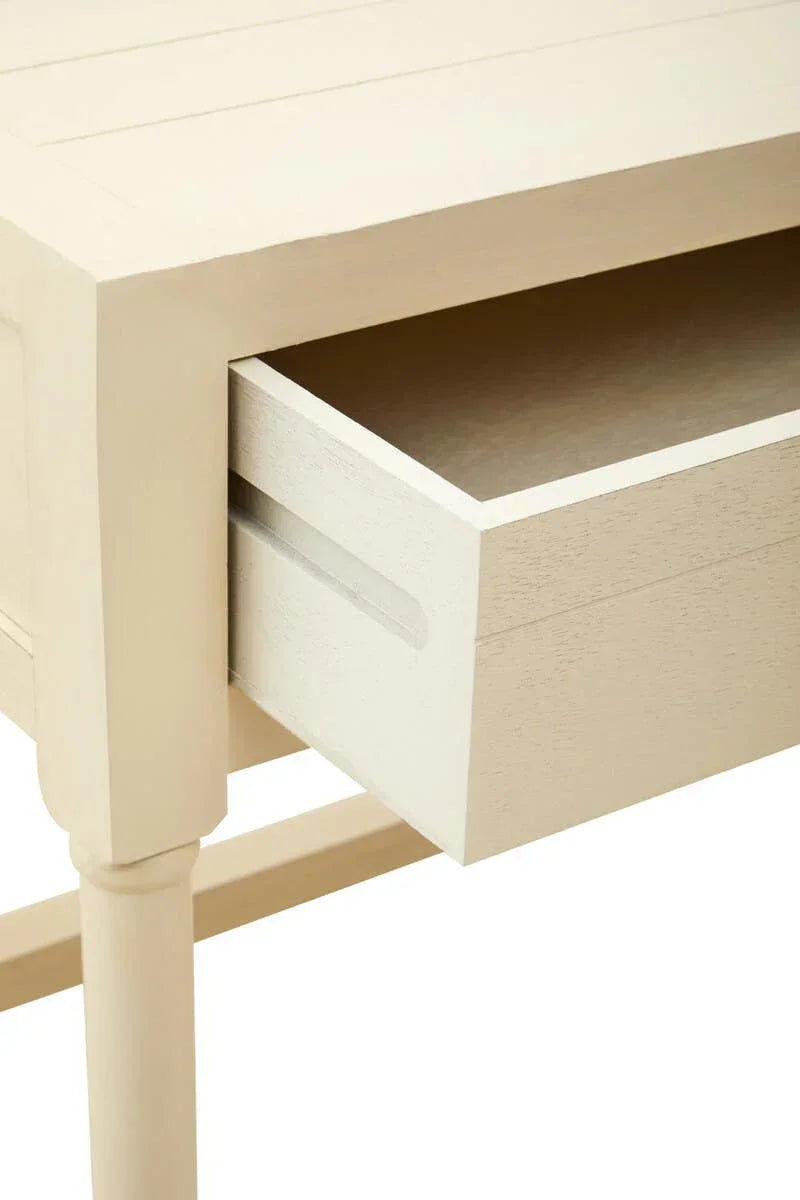 Closeup of wooden cream bedside table with open drawer and grooved handle