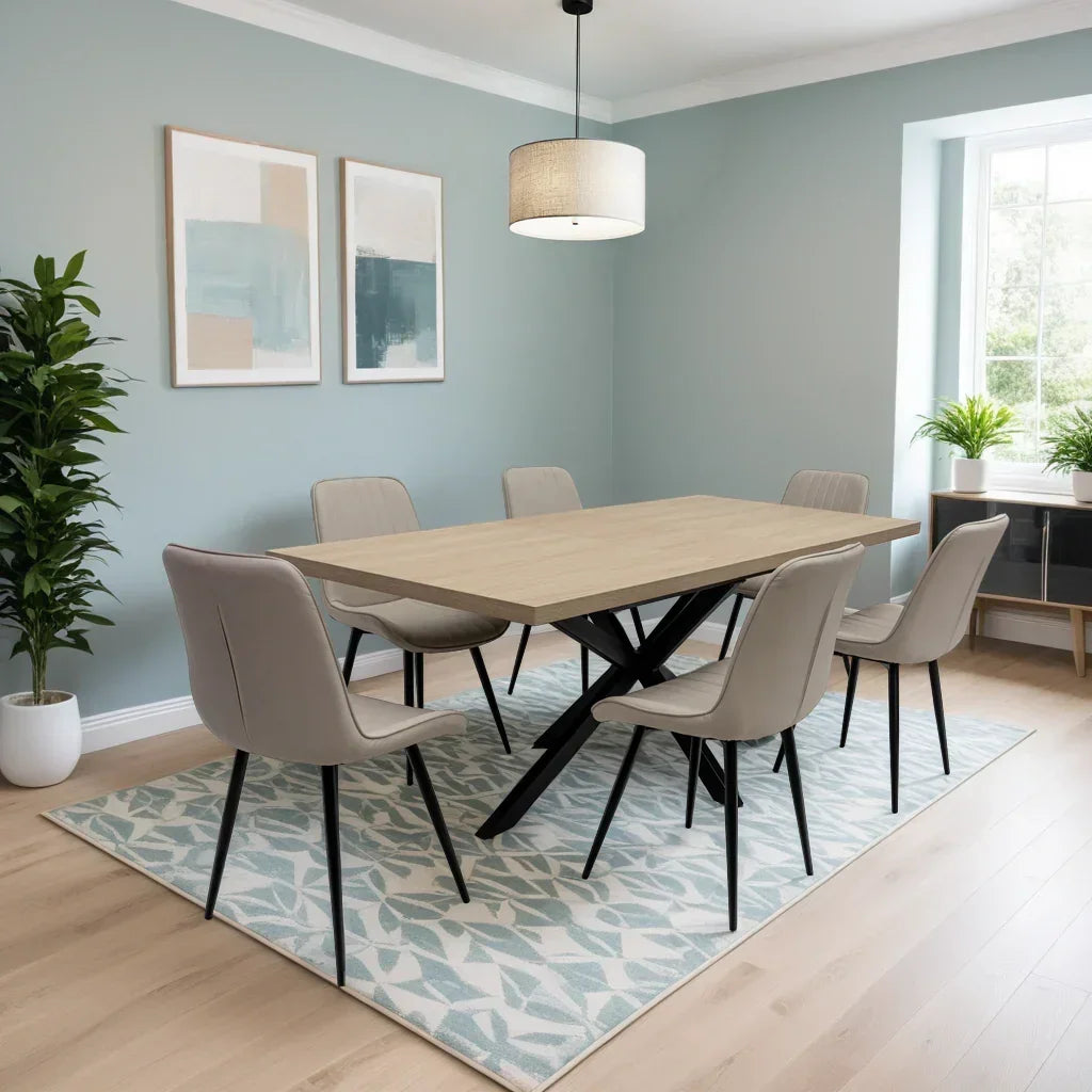 Rectangular wood dining table with six beige chairs on patterned rug in modern dining room