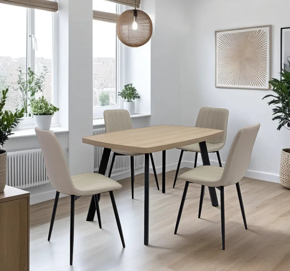 Beige dining chair with black metal legs at wood dining table in bright dining room