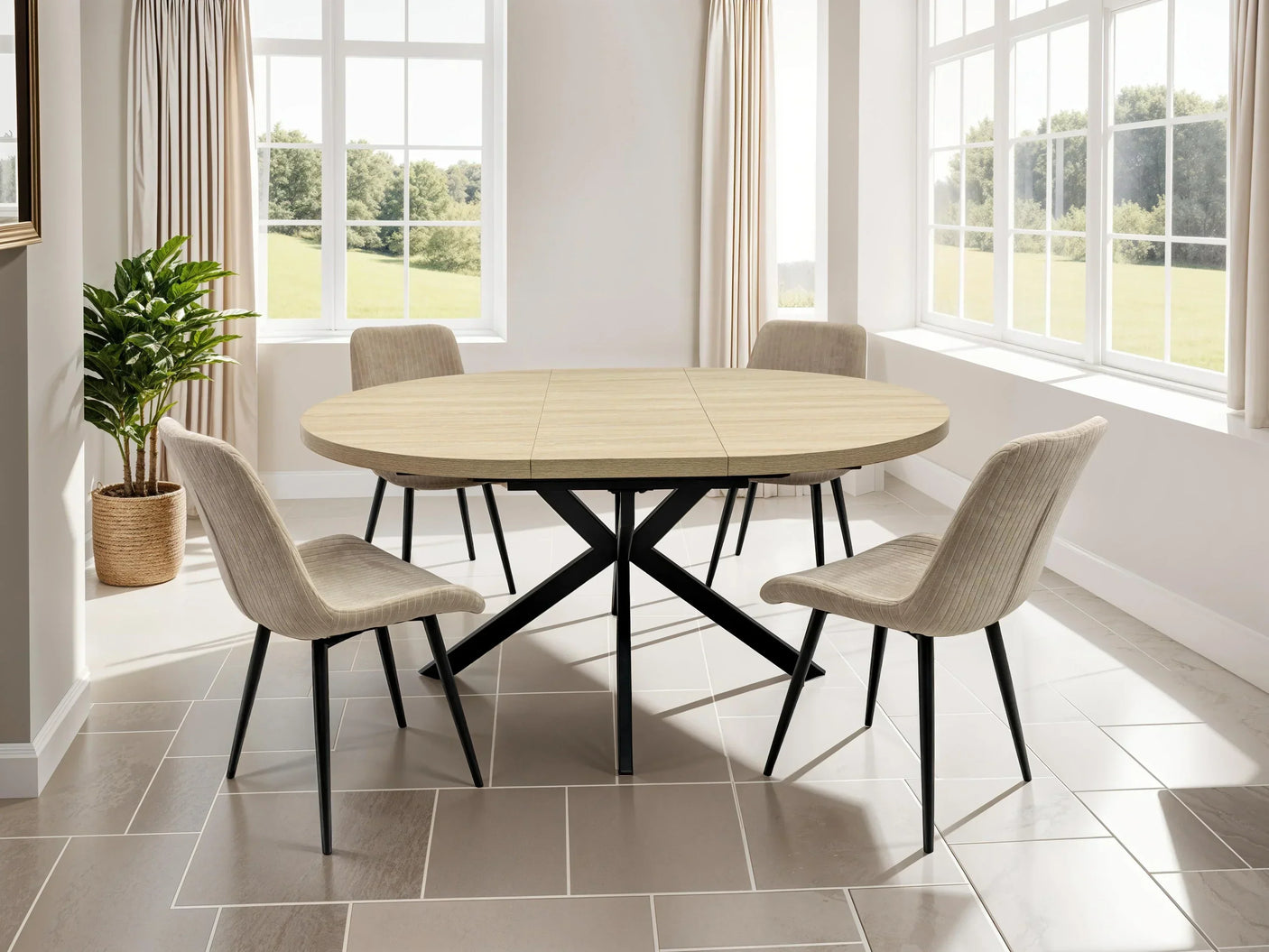 Round oak dining table with black metal legs and four beige chairs in sunlit dining room