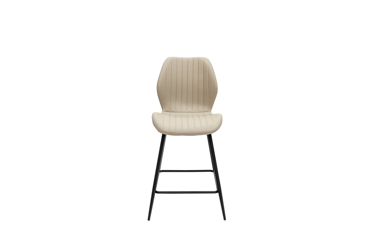 A modern bar stool with a ribbed beige upholstered seat and backrest, supported by slim black metal legs, shown against a plain white background.