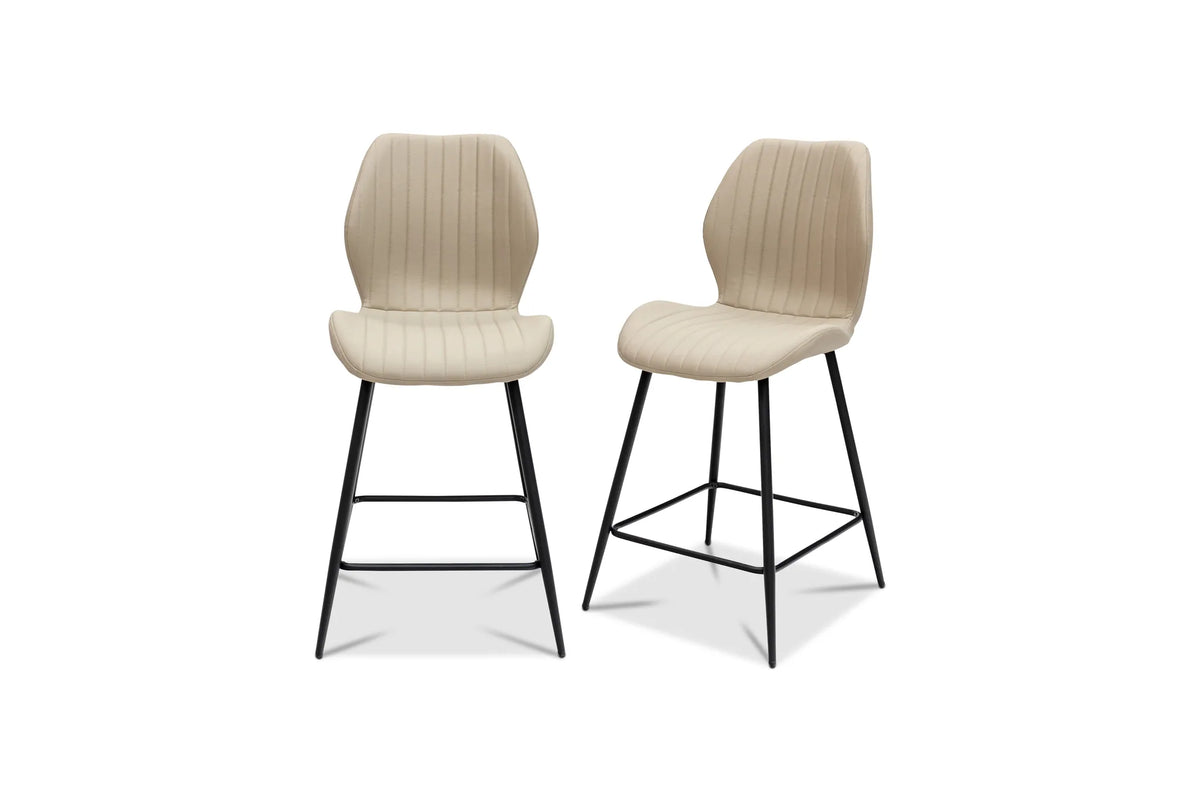 Two modern bar stools with beige ribbed upholstered seats and backs and black metal legs, shown on a plain white background.