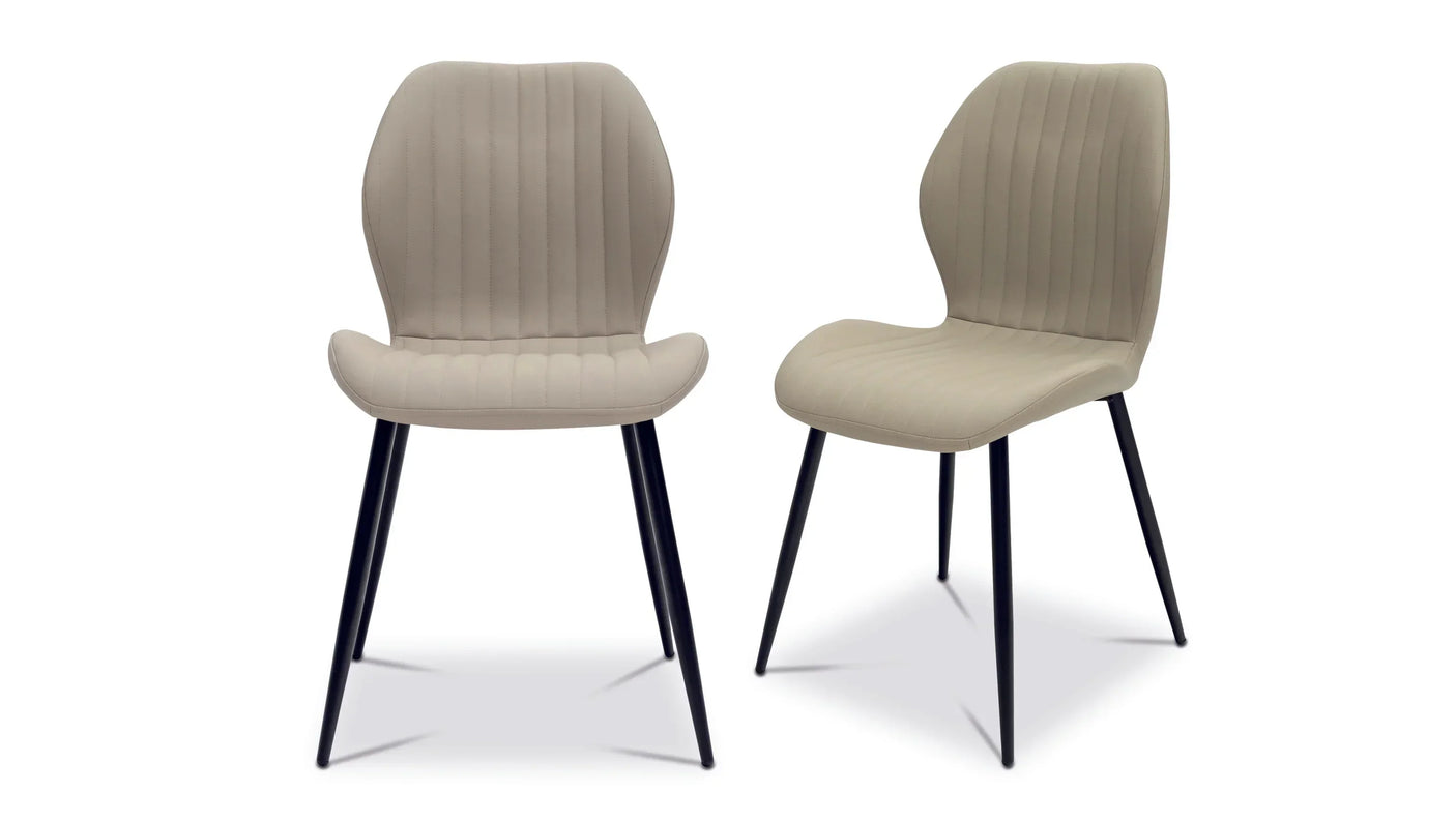 Pair of beige dining chairs with black metal legs and vertical stitching on seat and backrest