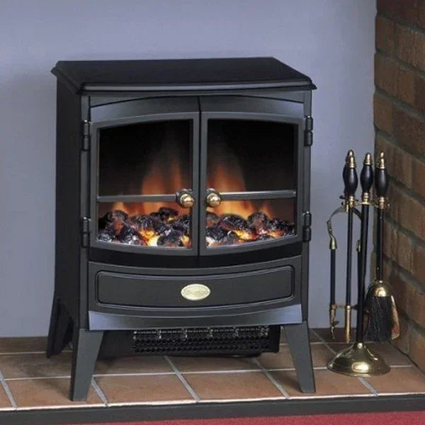 Freestanding electric stove heater with glass doors and log effect flame on tiled hearth
