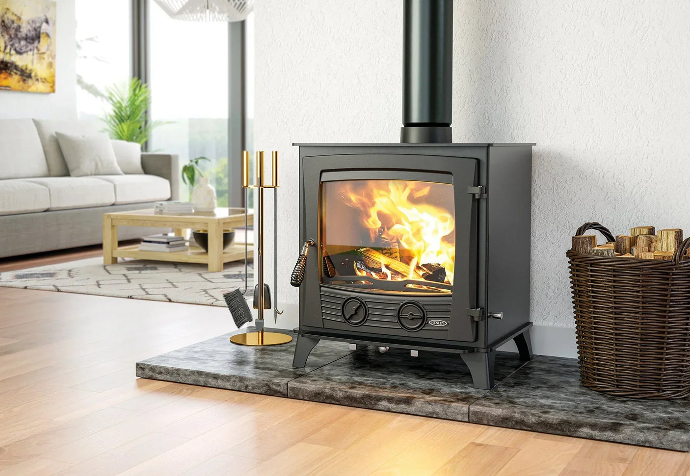 Black wood burning stove with glass front beside wicker log basket in modern living room