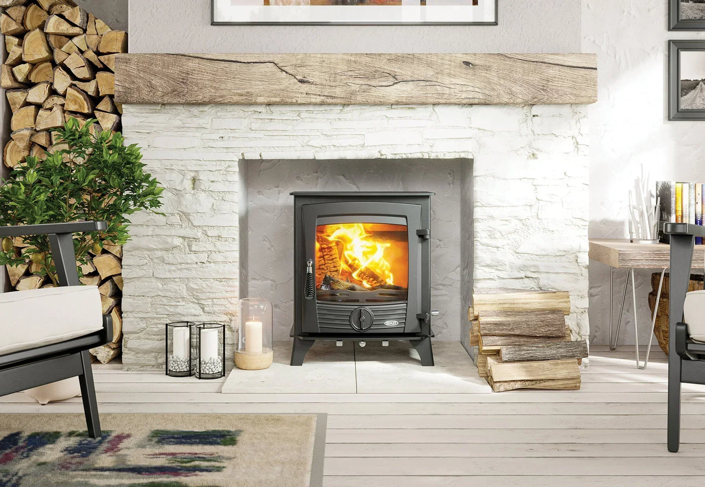 Black wood burning stove in stone fireplace with firewood and candles in modern living room