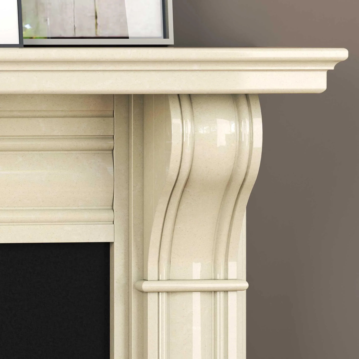 Close-up of cream marble fireplace surround with carved curved detailing