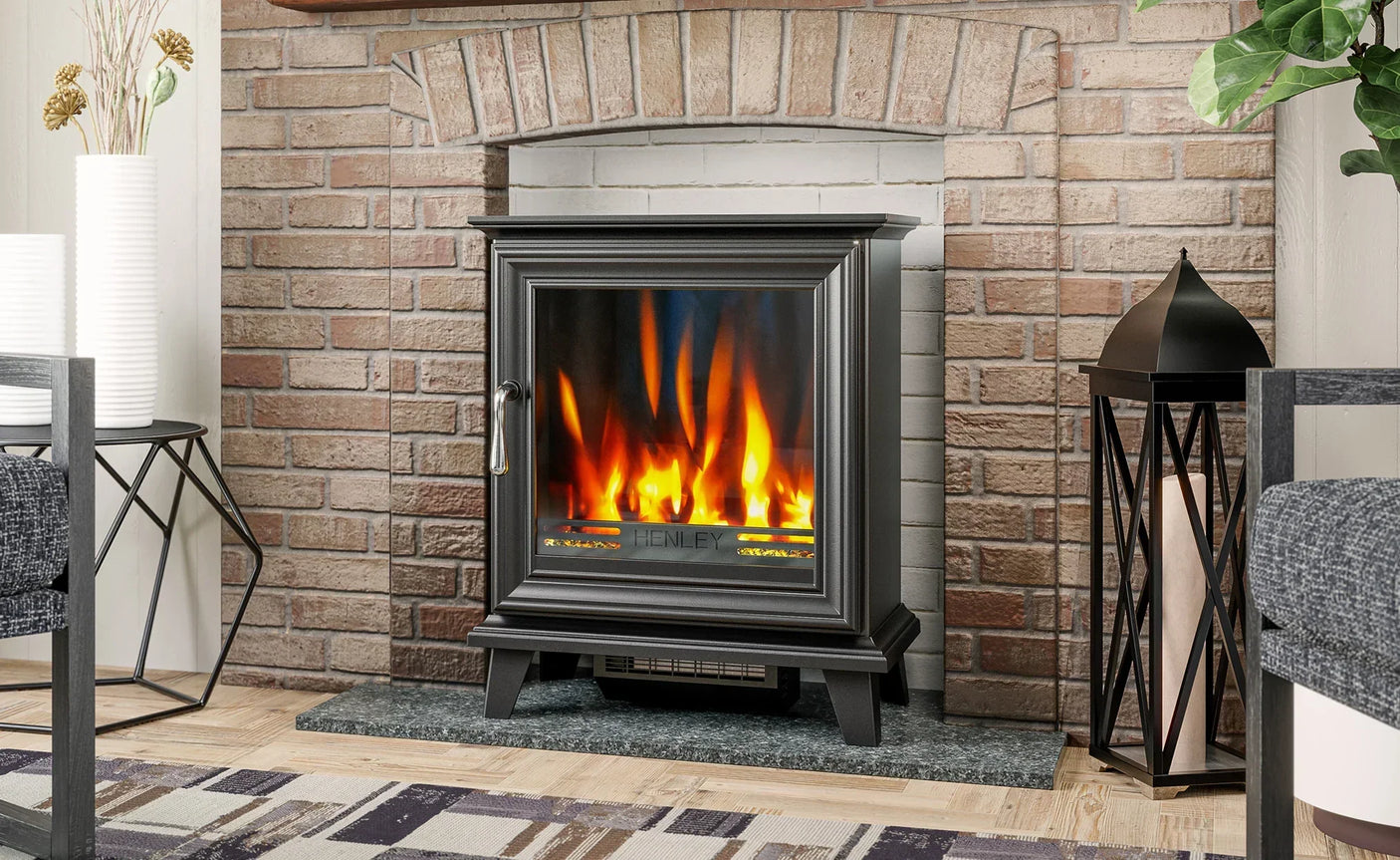 black electric stove heater with realistic flame effect in front of brick fireplace
