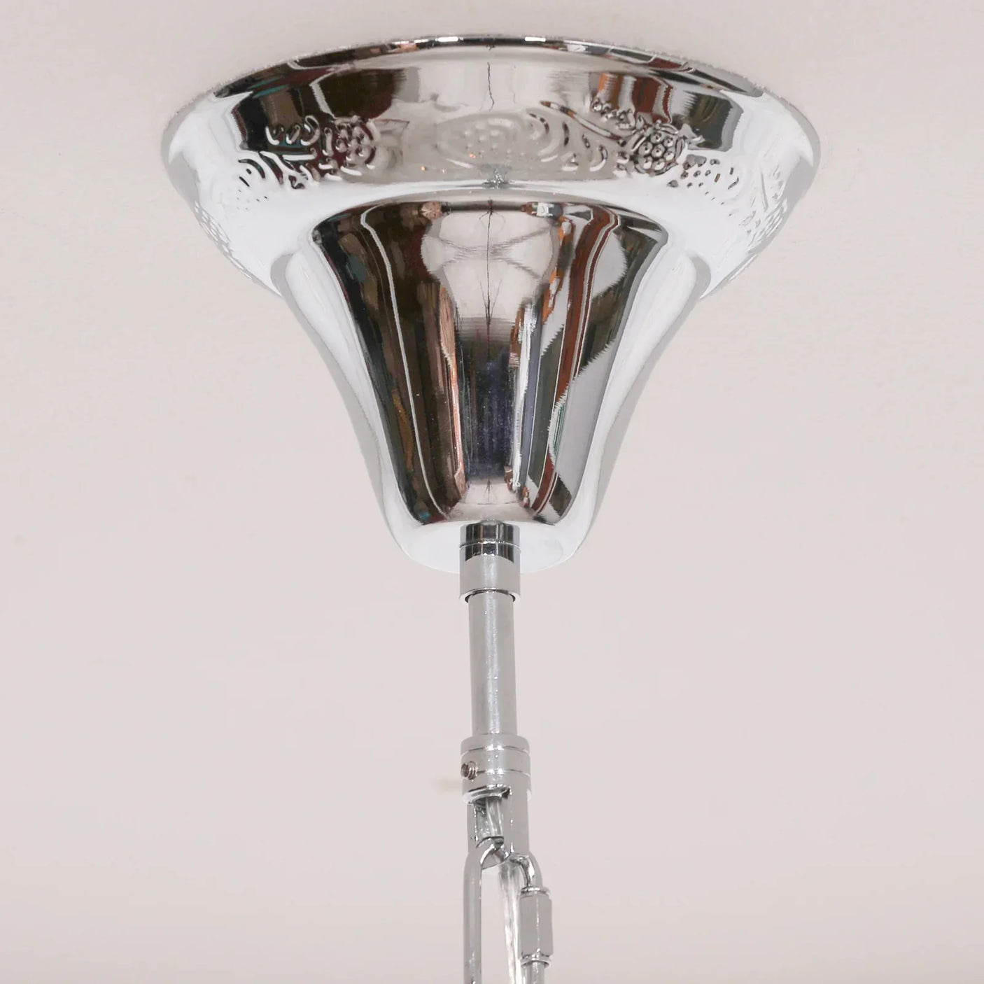 Ceiling light fixture with polished chrome canopy and decorative detailing