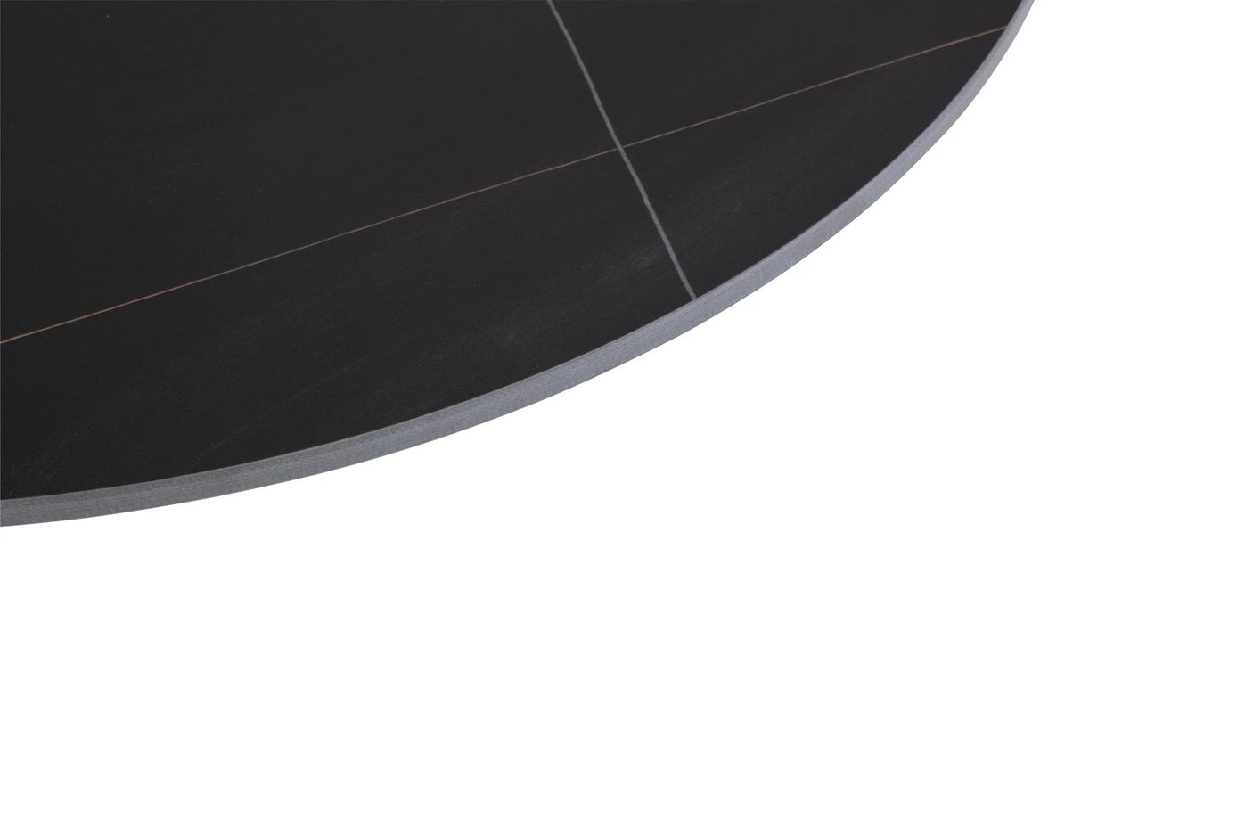 Close up of round black dining table top with subtle linear detailing