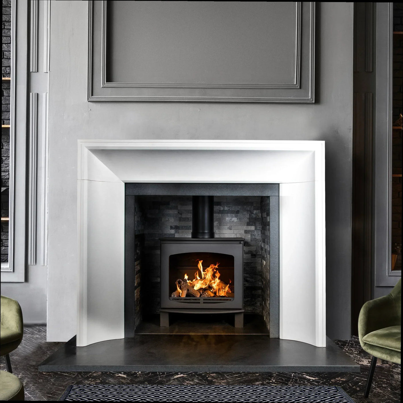 Limestone fireplace surround with modern wood burning stove and grey tiled interior