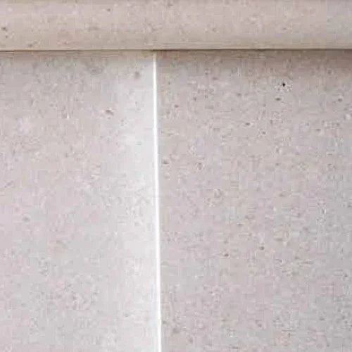 beige limestone fireplace surround with smooth textured surface and straight joint lines