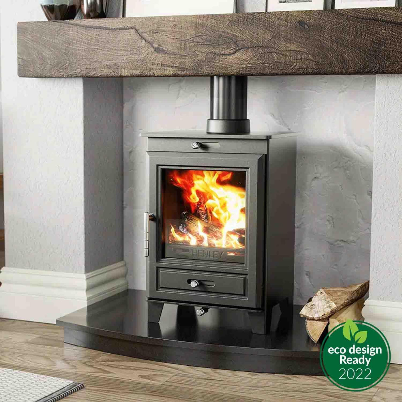 Black wood burning stove with glass door on hearth, log storage to side, eco label visible