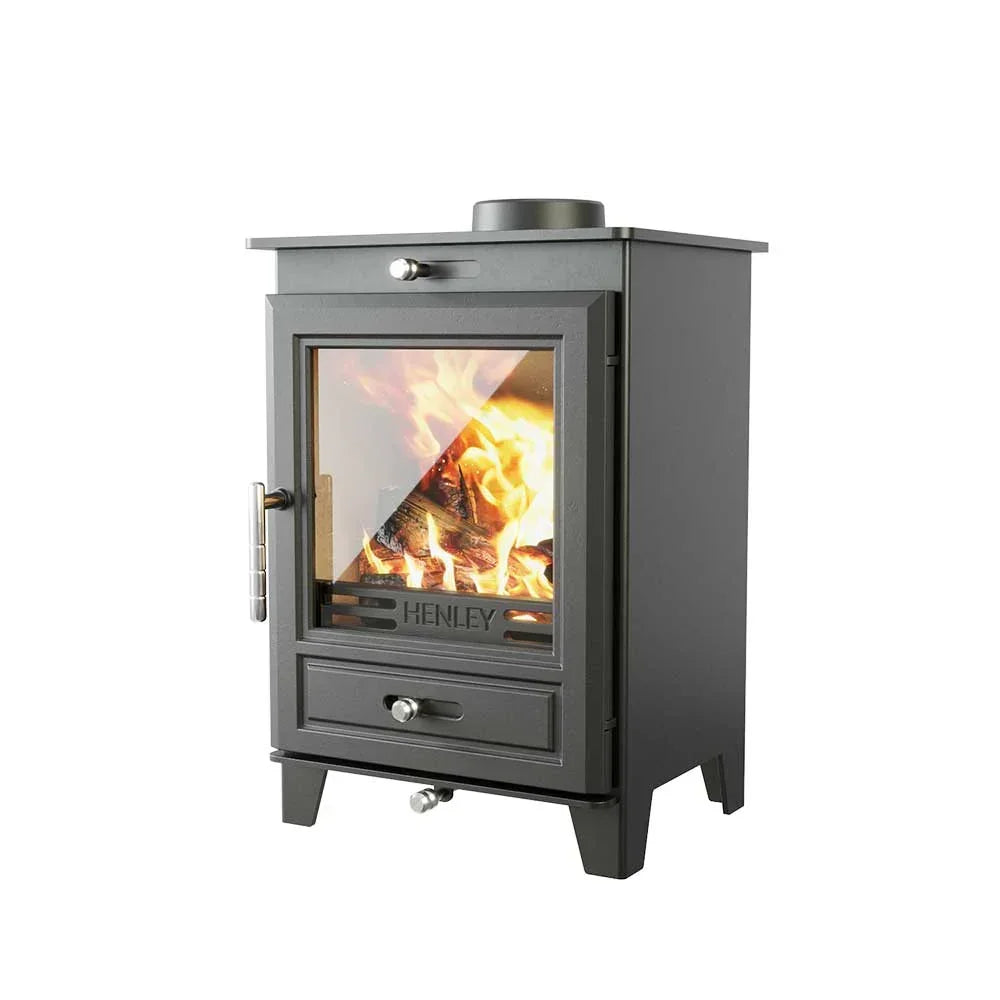 Black wood burning stove with glass door showing active flames and log inside