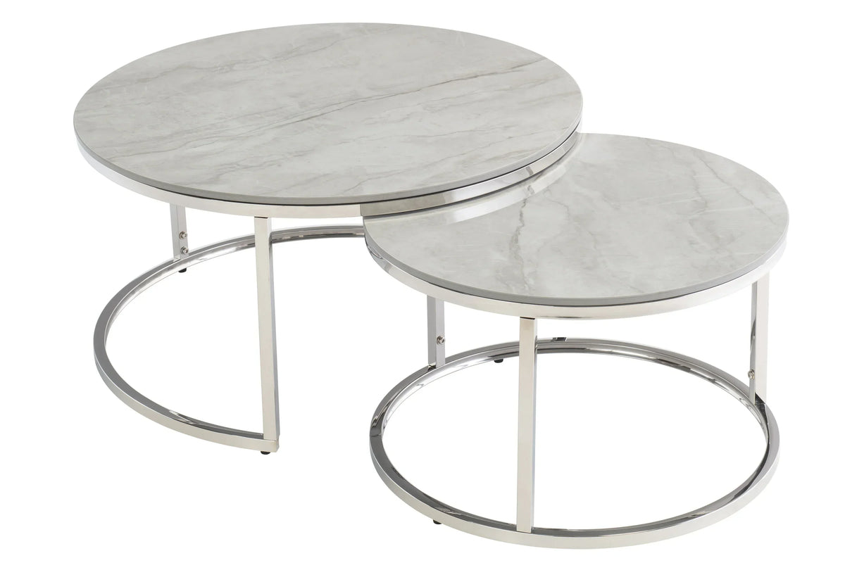 Round marble nesting coffee tables with chrome metal frames on white background