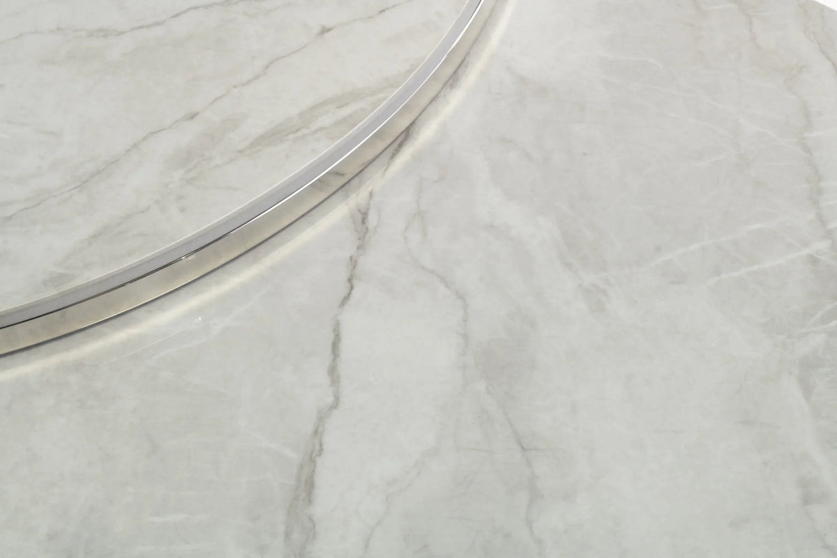 Close up of marble coffee table top with silver metal trim