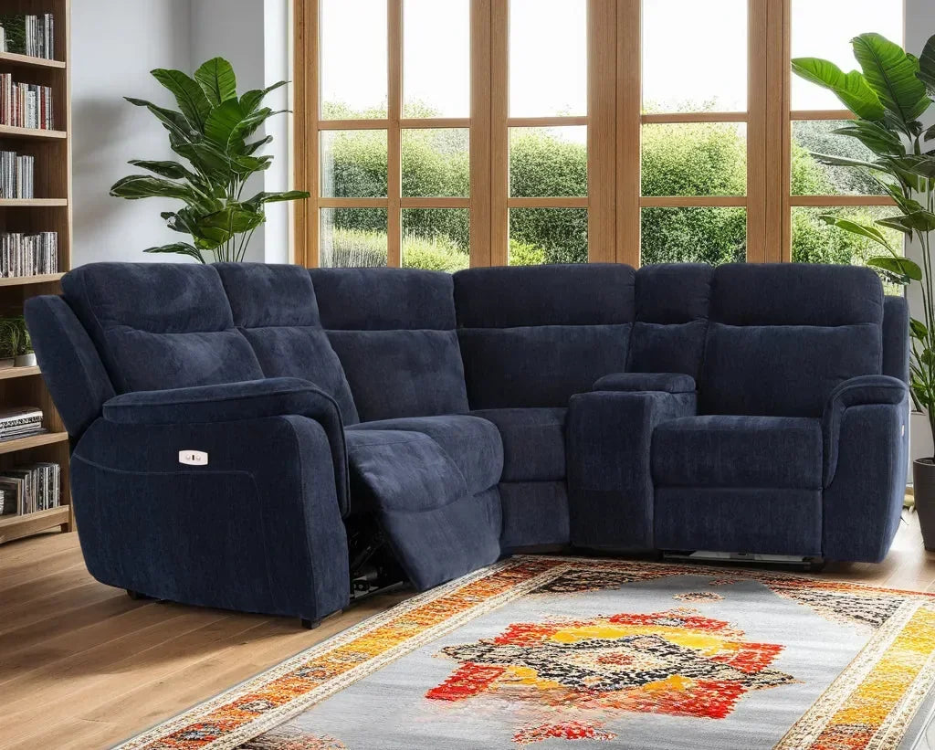 Blue fabric corner sofa with reclining seats in bright living room, near window and rug