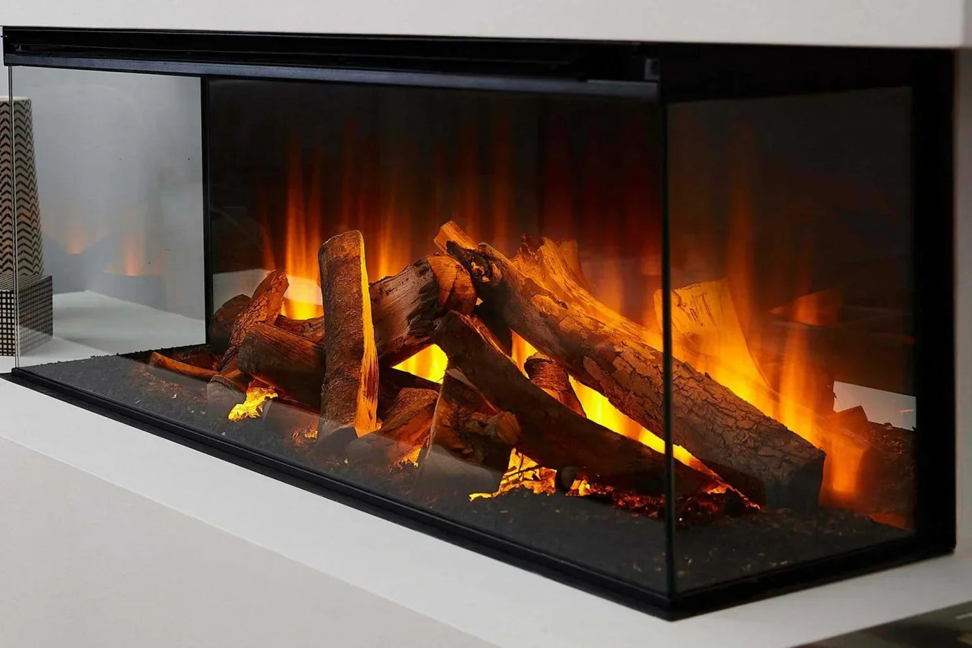 Deluxe real log electric fire with lifelike glowing embers in modern glass fireplace