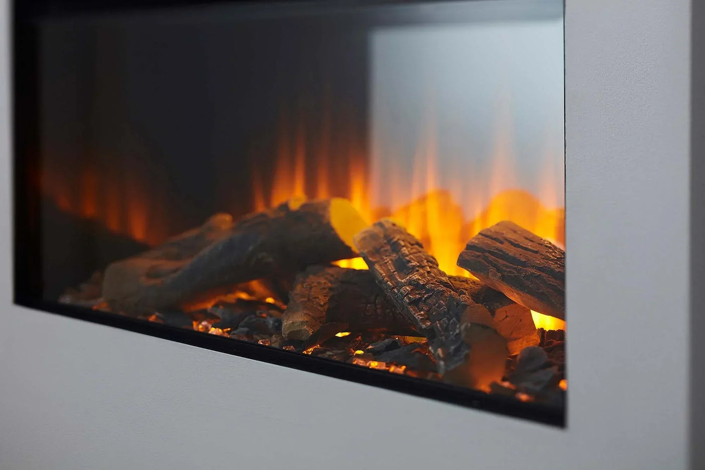 Electric fireplace with realistic glowing logs and flames inset in a modern wall unit