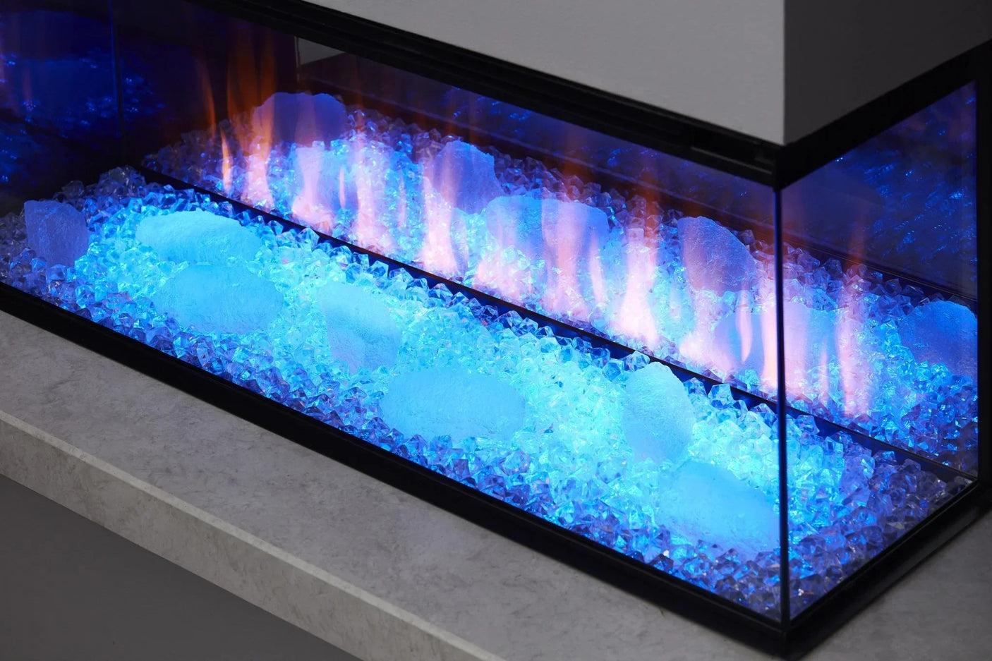 Electric fireplace close-up with blue LED lighting and decorative glass crystals